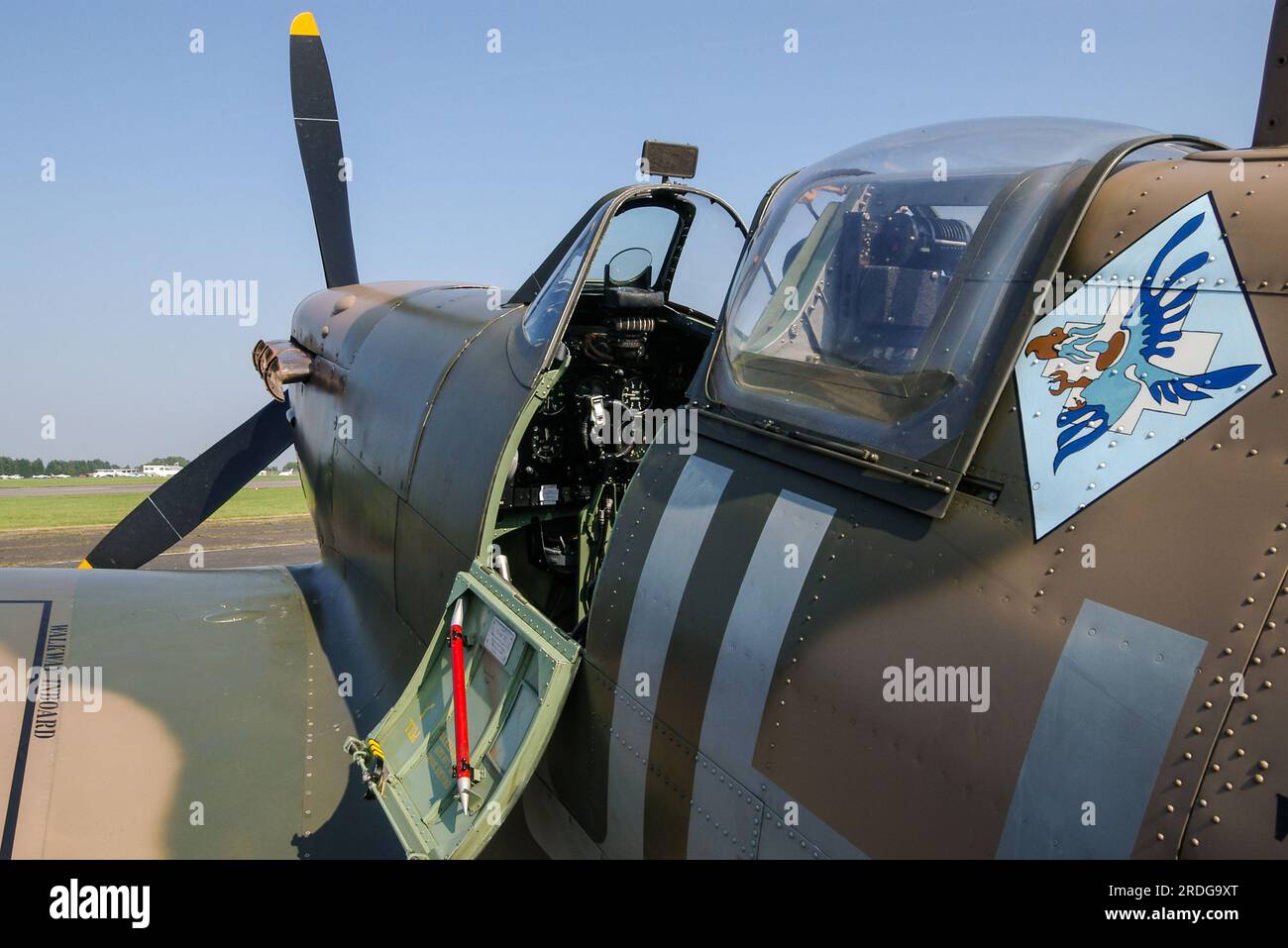 Cockpit of Second World War Spitfire V fighter plane BM597 of Historic Aircraft Collection. Emblem of No. 317 'City of Wilno' Polish Fighter Squadron Stock Photo