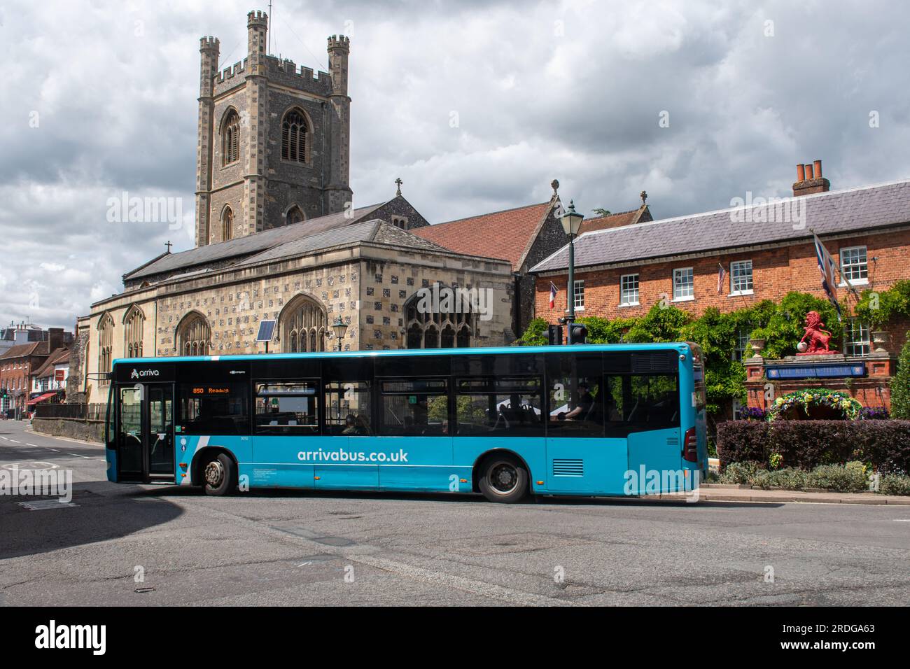 An Arriva bus, public transport, in Henley-on-Thames town centre, Oxfordshire, England, UK, passing St. Mary's Church Stock Photo