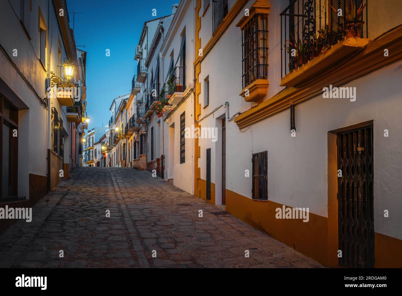 Illuminated Ronda Street at night - Ronda, Andalusia, Spain Stock Photo
