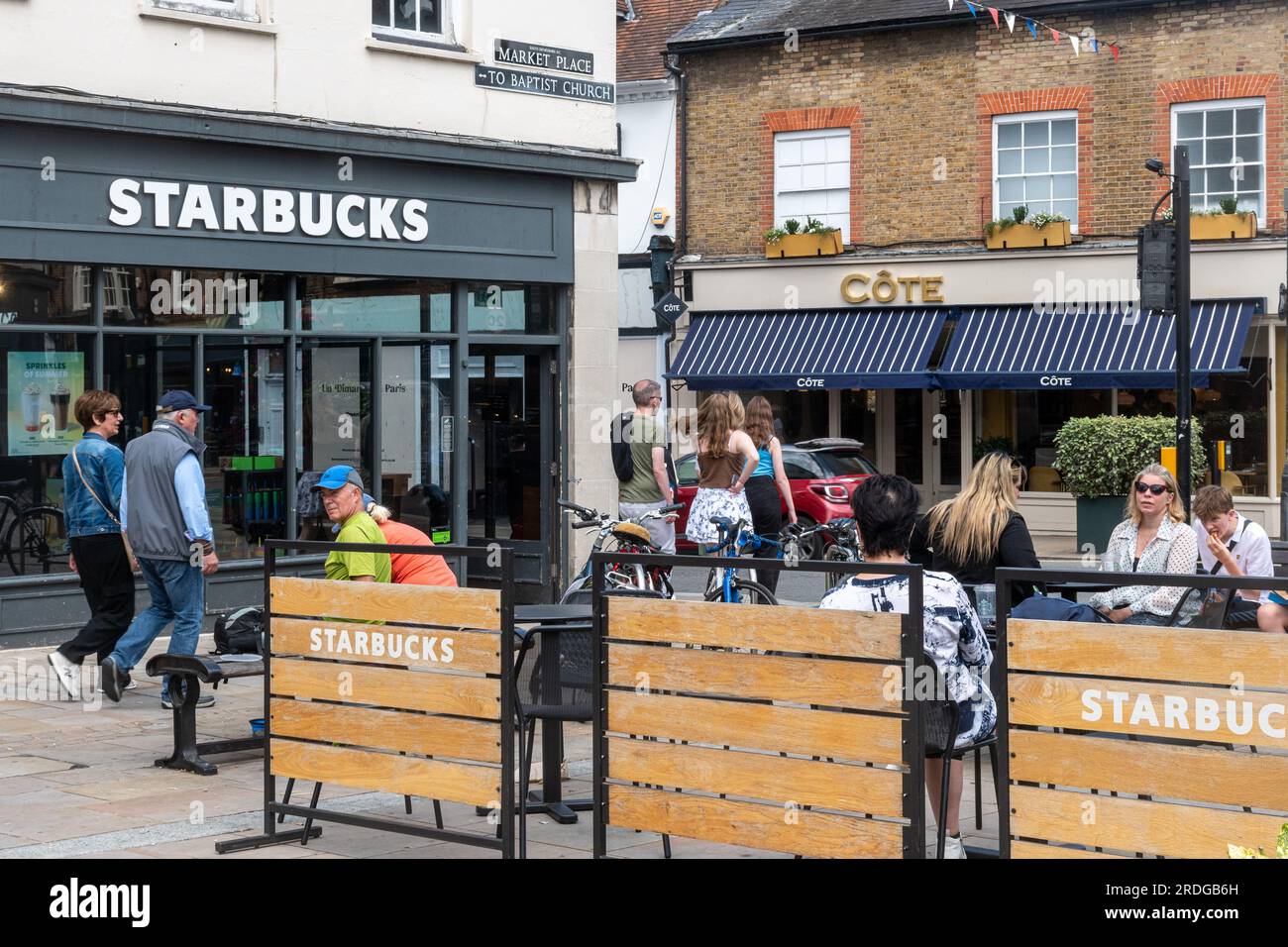 People sitting outside Starbucks coffee shop having drinks in Henley-on-Thames town centre, Oxfordshire, England, UK Stock Photo