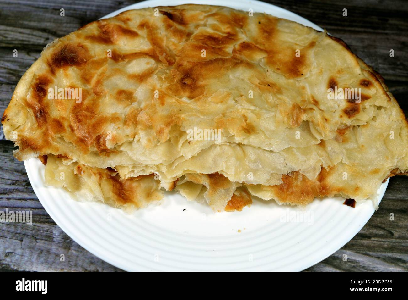 Egyptian Feteer meshaltet, layers upon layers of pastry dough with loads of ghee or butter in between, one of the famous Egyptian pastry recipes, a fl Stock Photo