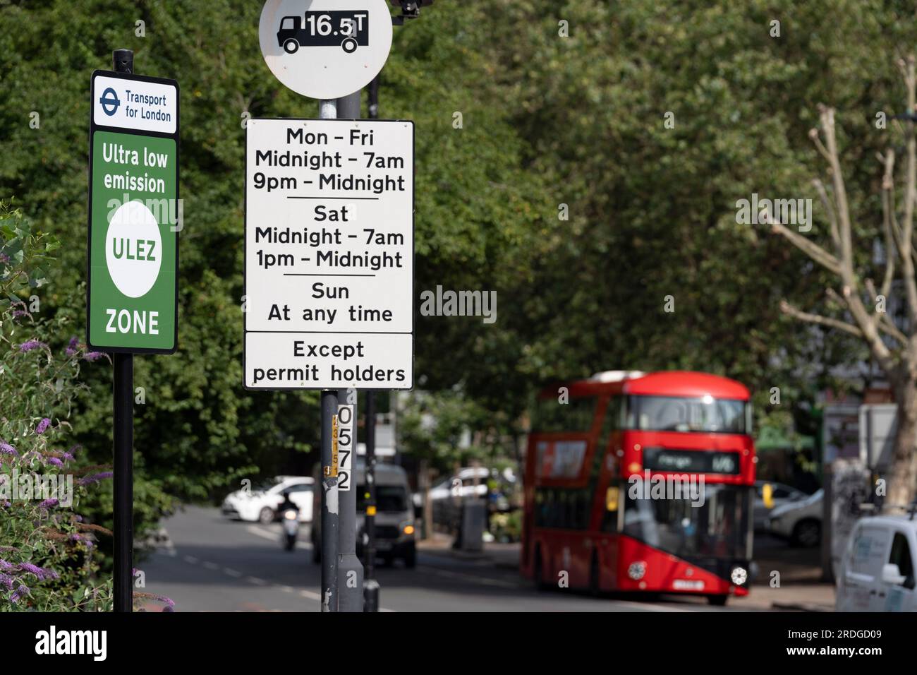 A local bus passes an ULEZ (Ultra Low Emission Zone) sign on the South Circular at East Dulwich, on 21st July 2023, in London, England. Introduced by his Conservative predecessor Boris Johnson, London Mayor Sadiq Khan wants to expand the ULEZ area to a wider London to older vehicles such as polluting diesels and petrol cars, a controversial air quality policy to lower poisonous emissions that harms the health of 1 in 10 children. Drivers of non-exempt vehicles may enter the ULEZ after paying a £12.50 daily fee - or face a £160 penalty. Stock Photo