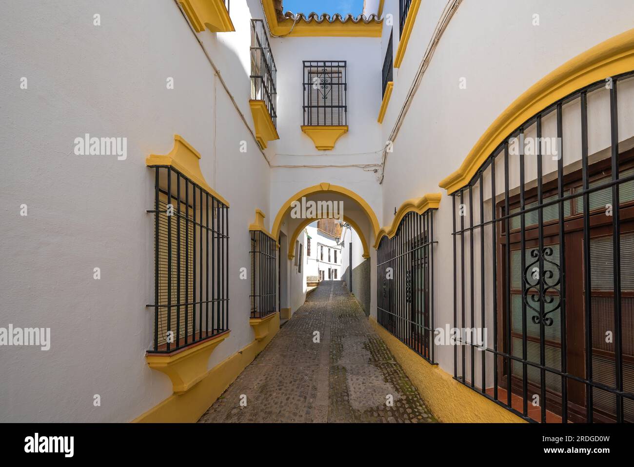 White and Yellow Ronda Street with Passaje Arch - Ronda, Andalusia, Spain Stock Photo