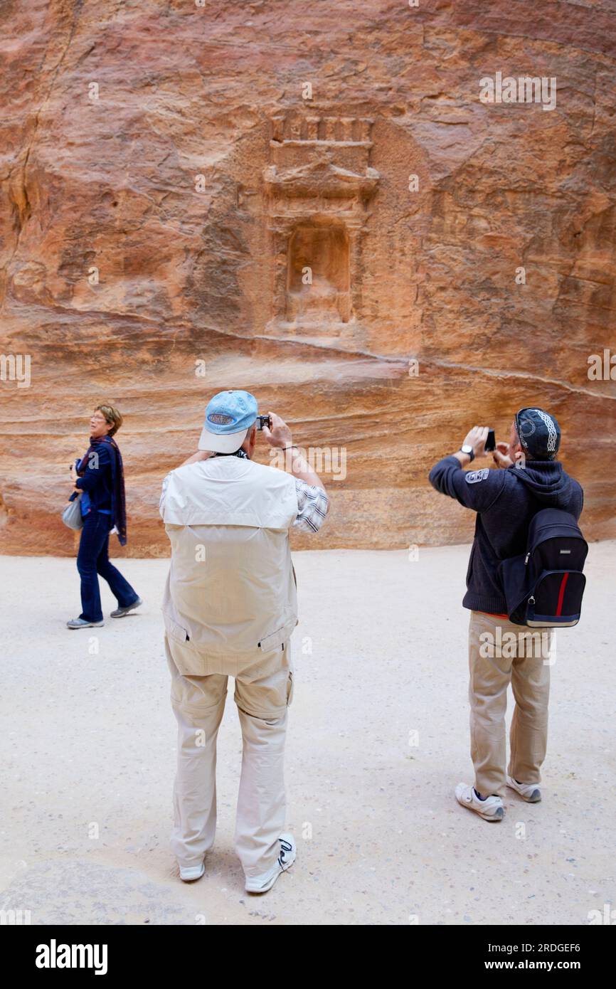 Tourist take photos of wall carving, The Siq, Petra, Ma'an Governorate, Jordan Stock Photo Alamy