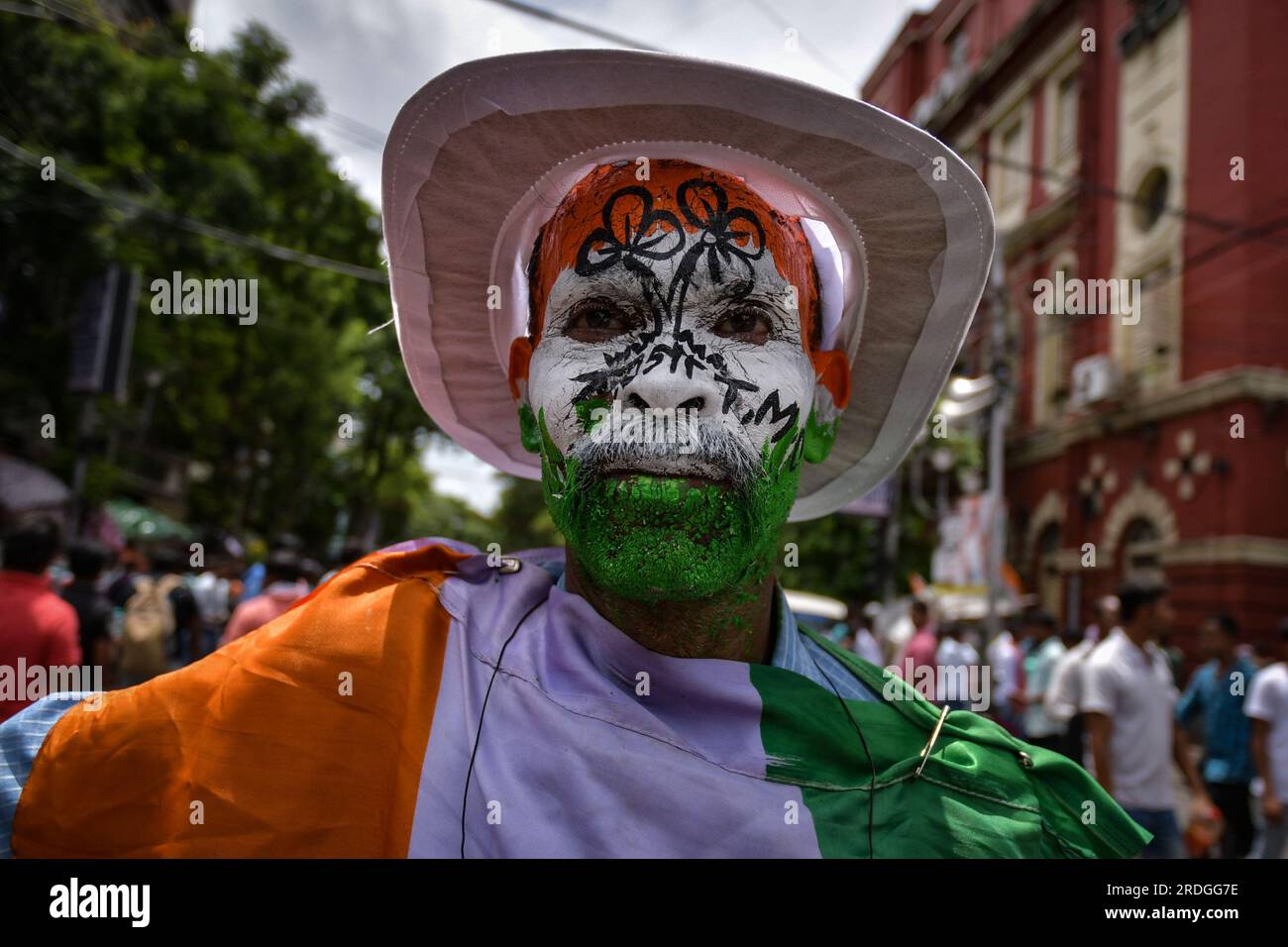 Kolkata, India. 21st July, 2023. A Trinamool Congress party supporter painted his face with party flag colors while participating in the mega Annual Martyrs Day program at the Esplanade area. Trinamool Congress party held the Annual Martyrs Day rally, TMC's biggest annual political event drawing massive crowd from all over the state to Esplanade area, the heart of Kolkata on every 21st July to commemorate the 13 people who were shot died by West Bengal police on 21st July 1993 during a rally held by then. Credit: SOPA Images Limited/Alamy Live News Stock Photo