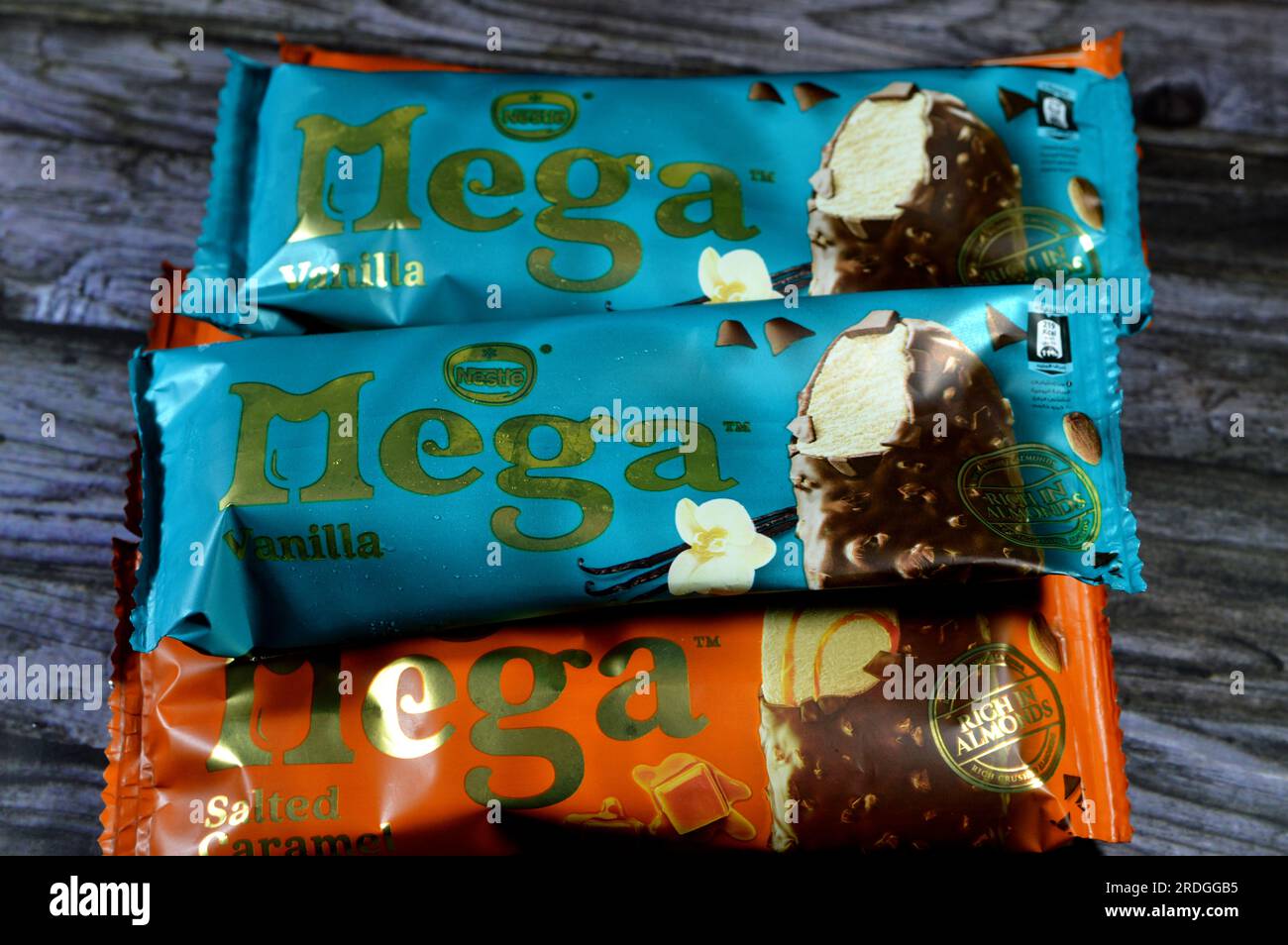 Cairo, Egypt, July 15 2023: Nestle Mega Salted Caramel and Vanilla almonds ice cream sticks coated and covered with dark chocolate, Rich flavored ice Stock Photo