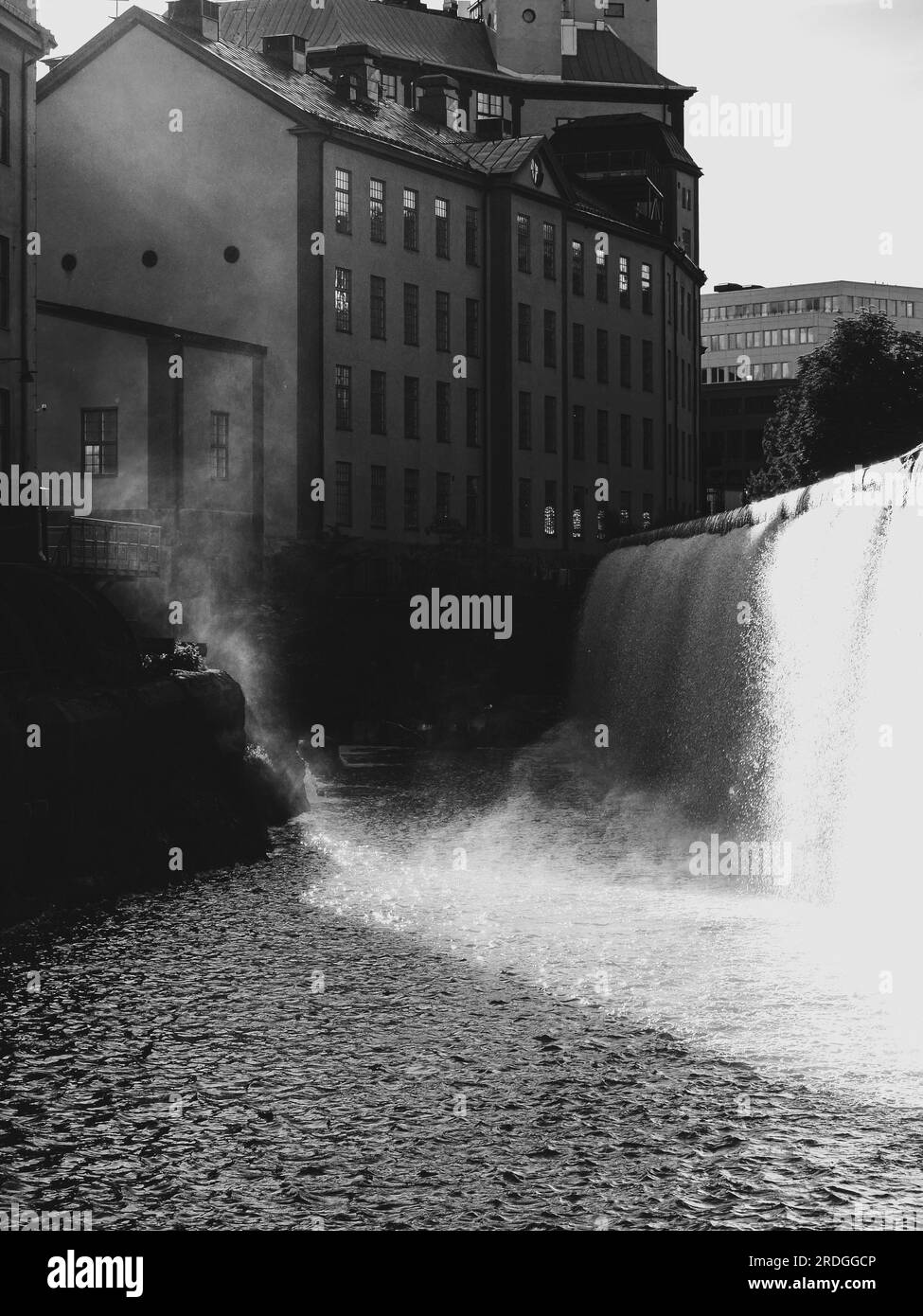 A waterfall at old industrial buildings Stock Photo