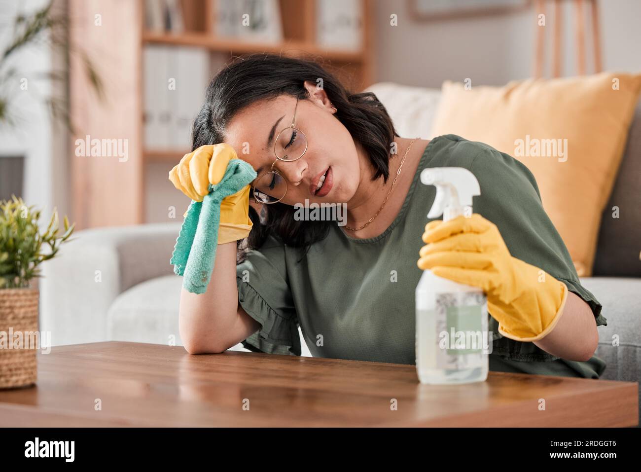 Tired woman, housekeeper and headache with detergent for cleaning
