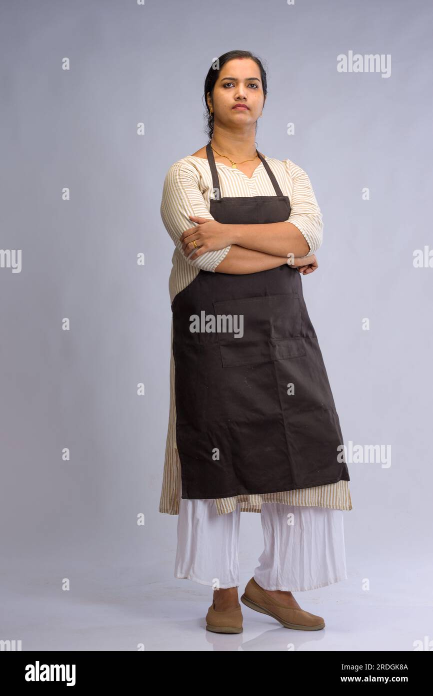 Indian women chef, potrait of a lady wearing apron with white background, isolated Stock Photo