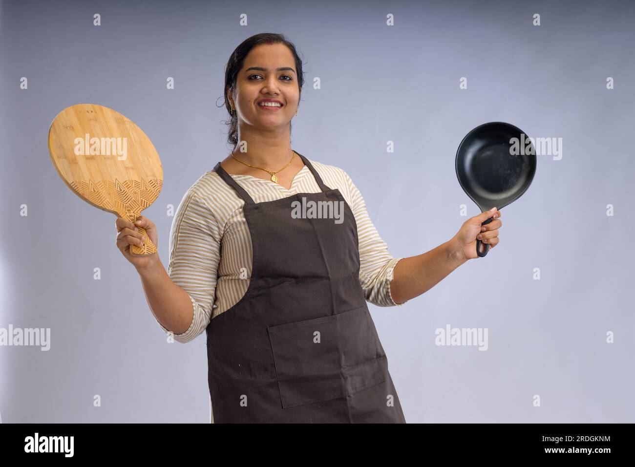 Indian women chef, potrait of a lady wearing apron with white background, isolated Stock Photo