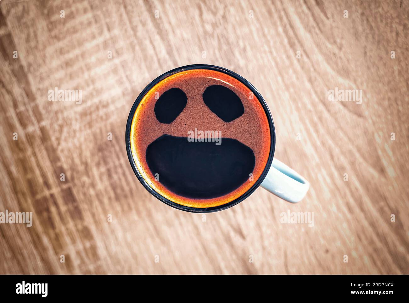 Coffee cup with funny screaming in fear face, top view. Open crying