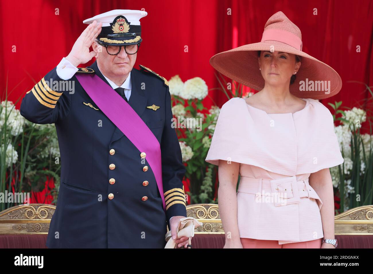 Belgian Prince Laurent (L) is pictured with Princess Claire (R) and her  daughter Princess Louise on the podium during the military parade on the  occasion of Belgium?s National Day in Brussels, Belgium