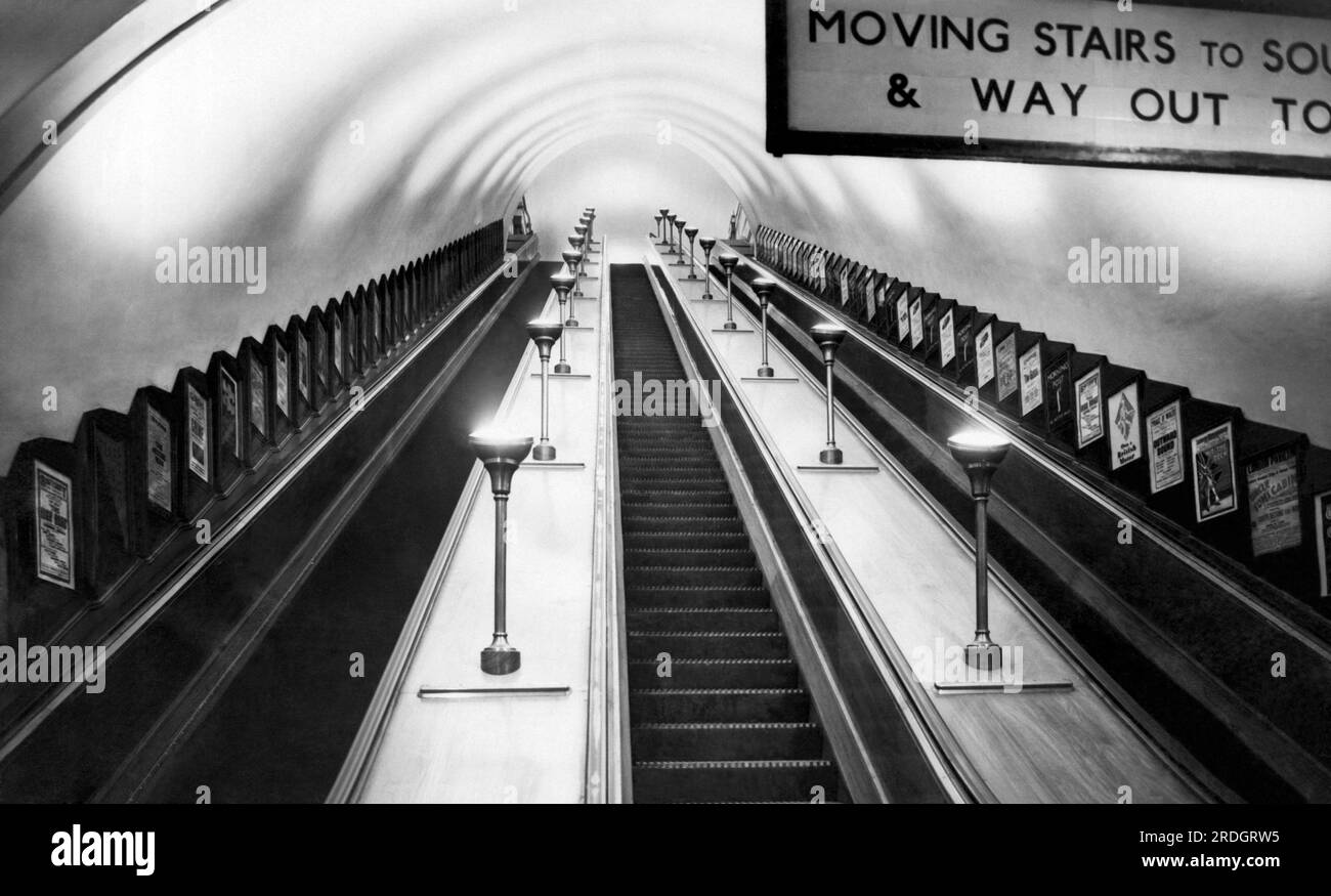 London, England: c. 1934 A view of the escalators in the Tube Station ...
