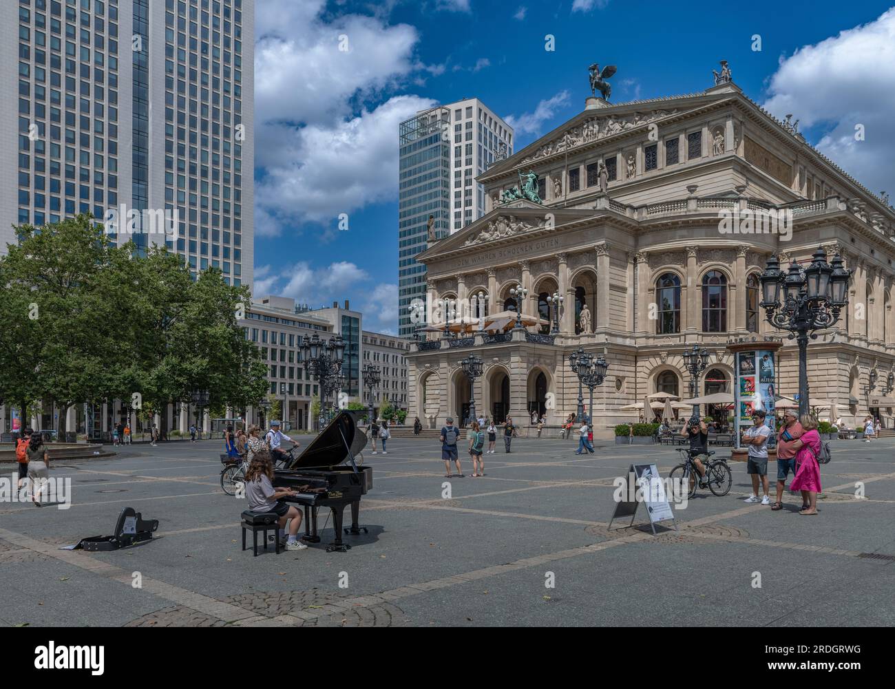 Young piano player in front of the Alte Oper, Frankfurt, Germany Stock Photo