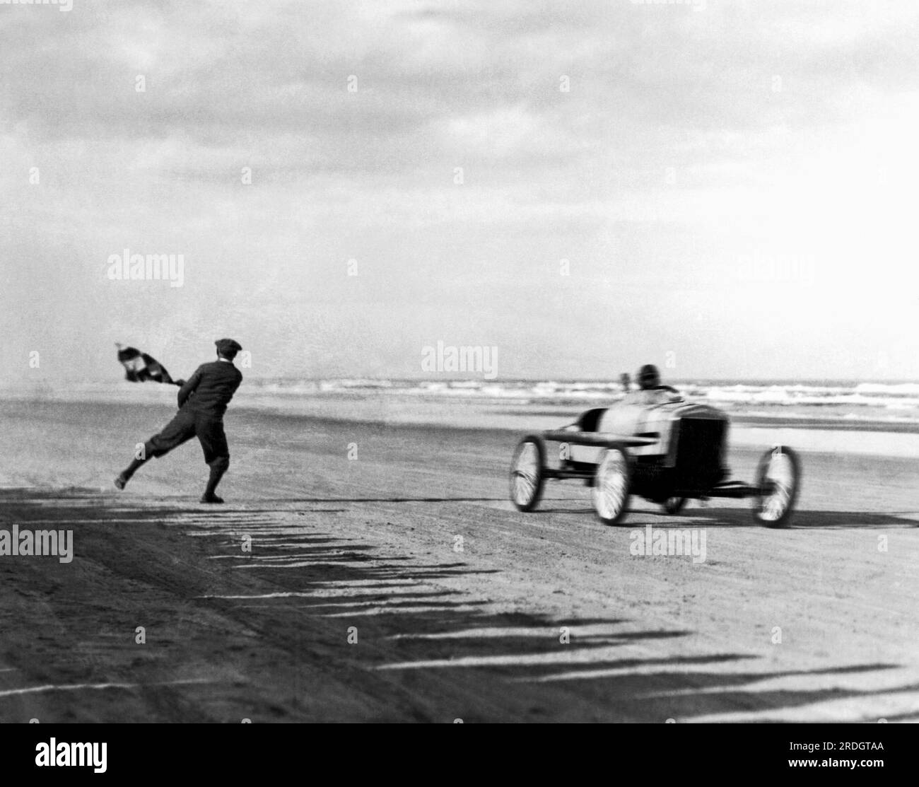 Daytona Beach, Florida:  January 1, 1926 Sig Haugdahl gets the checkered flag as he wins the opening event of the New Year's Day Races in his Daytona Cyclone race car. Stock Photo