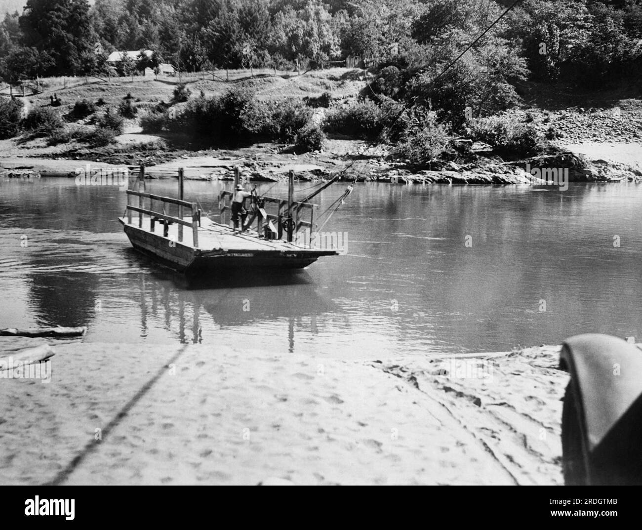 Hoopa, California:  c. 1928 A ferry used to cross the Trinity River on the Hupa Native American Reservation in Humboldt County. Stock Photo