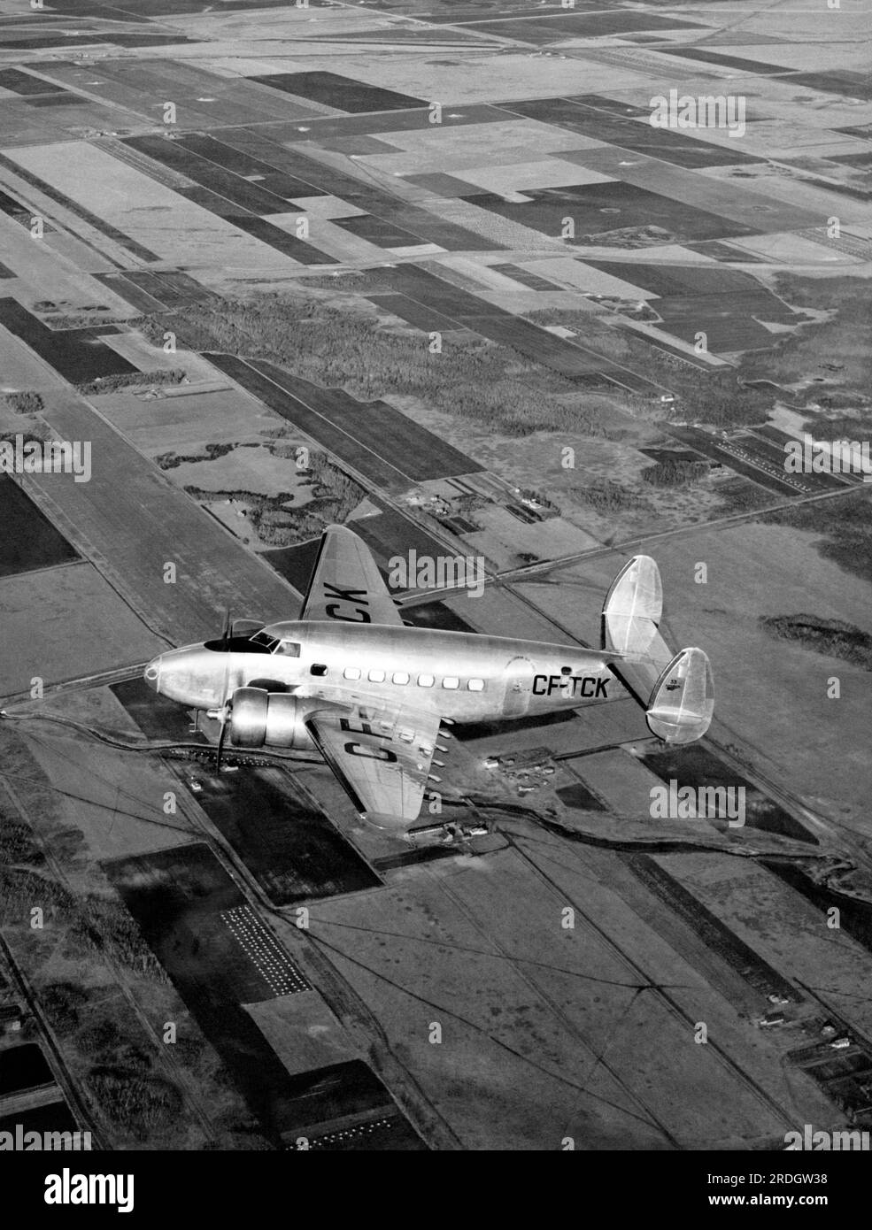 Manitoba, Canada, 1939 Trans-Canada Air Lines' new Lockheed 14H2 flying over the prairies of western Canada. It carried 10 passengers and flew between Vancouver and Montreal. Stock Photo