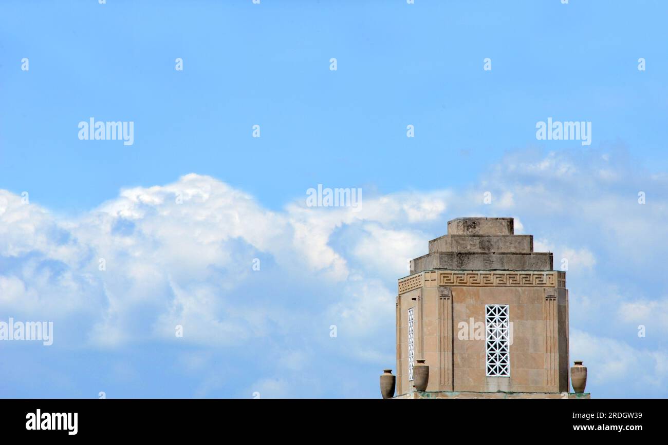 El Dorado's City Hall is framed by blue sky and fluffy clouds.  Historic landmark sits in corner of image. Stock Photo
