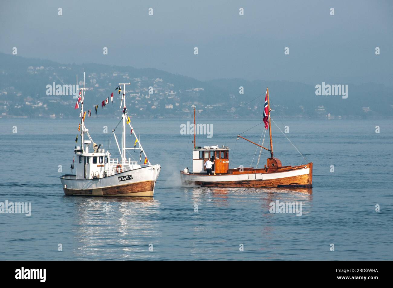 Around Bergen - Two small fishing vessels heading into port Stock Photo