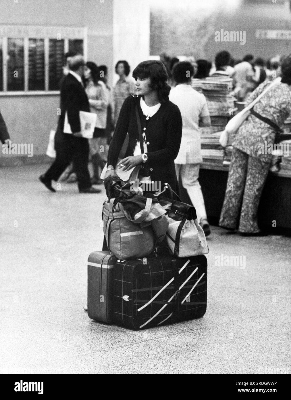 New York, New York:  September 3, 1972 A woman stands with her luggage at the Port Authority Bus Terminal. Stock Photo