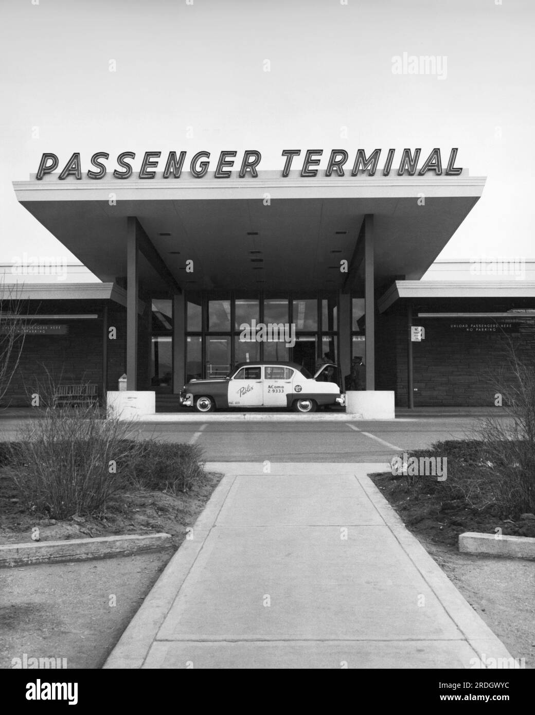 Denver, Colorado:  c. 1954 A taxi cab at the entrance to the passenger terminal at Stapleton International Airport. Stock Photo