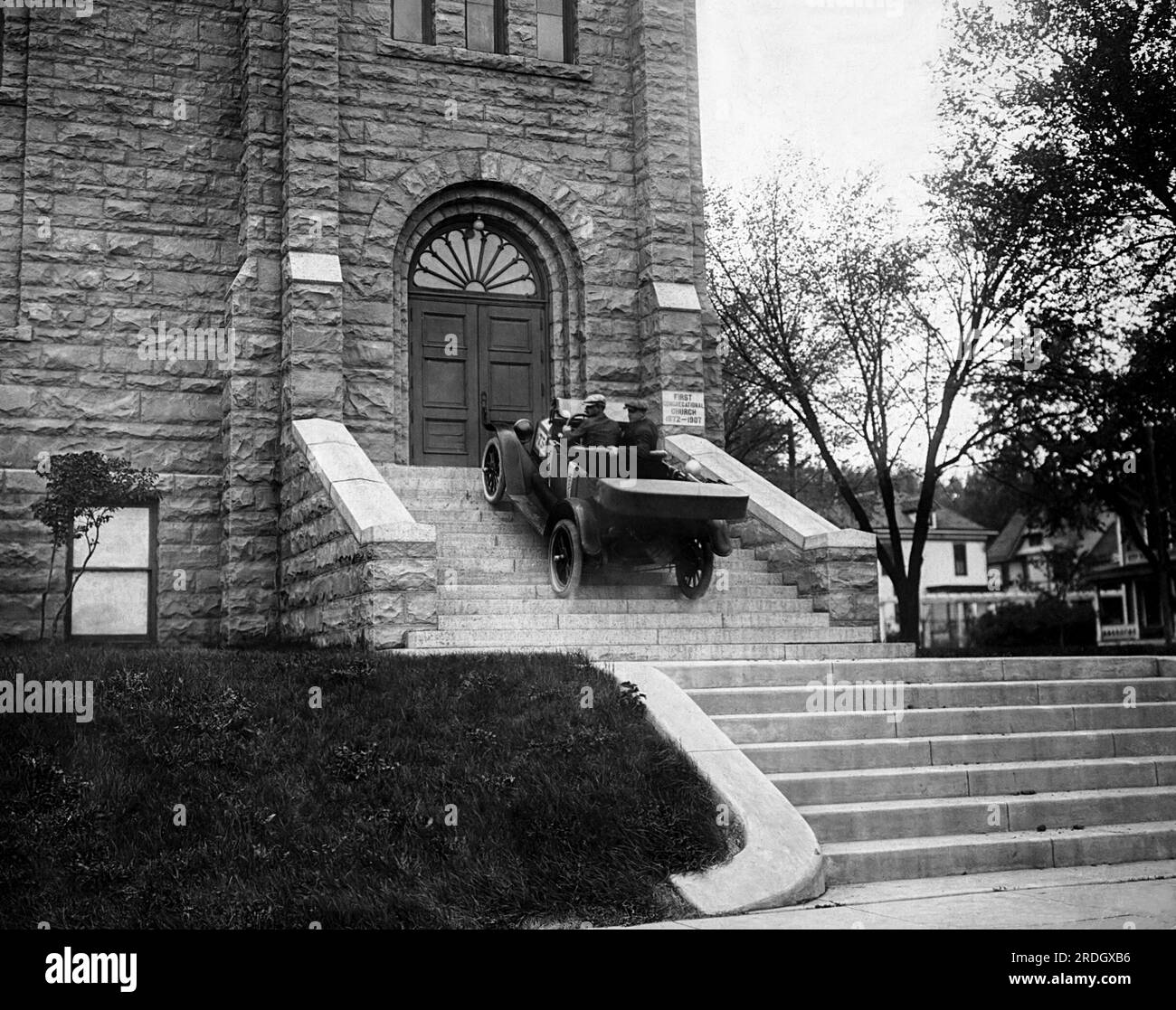 Sioux Falls, South Dakota:  c. 1915 A Maxwell car climbs the steps of the Congregational Church in Sioux Falls. It was part of a promotional campaign by the Hessenius Auto Company. Stock Photo