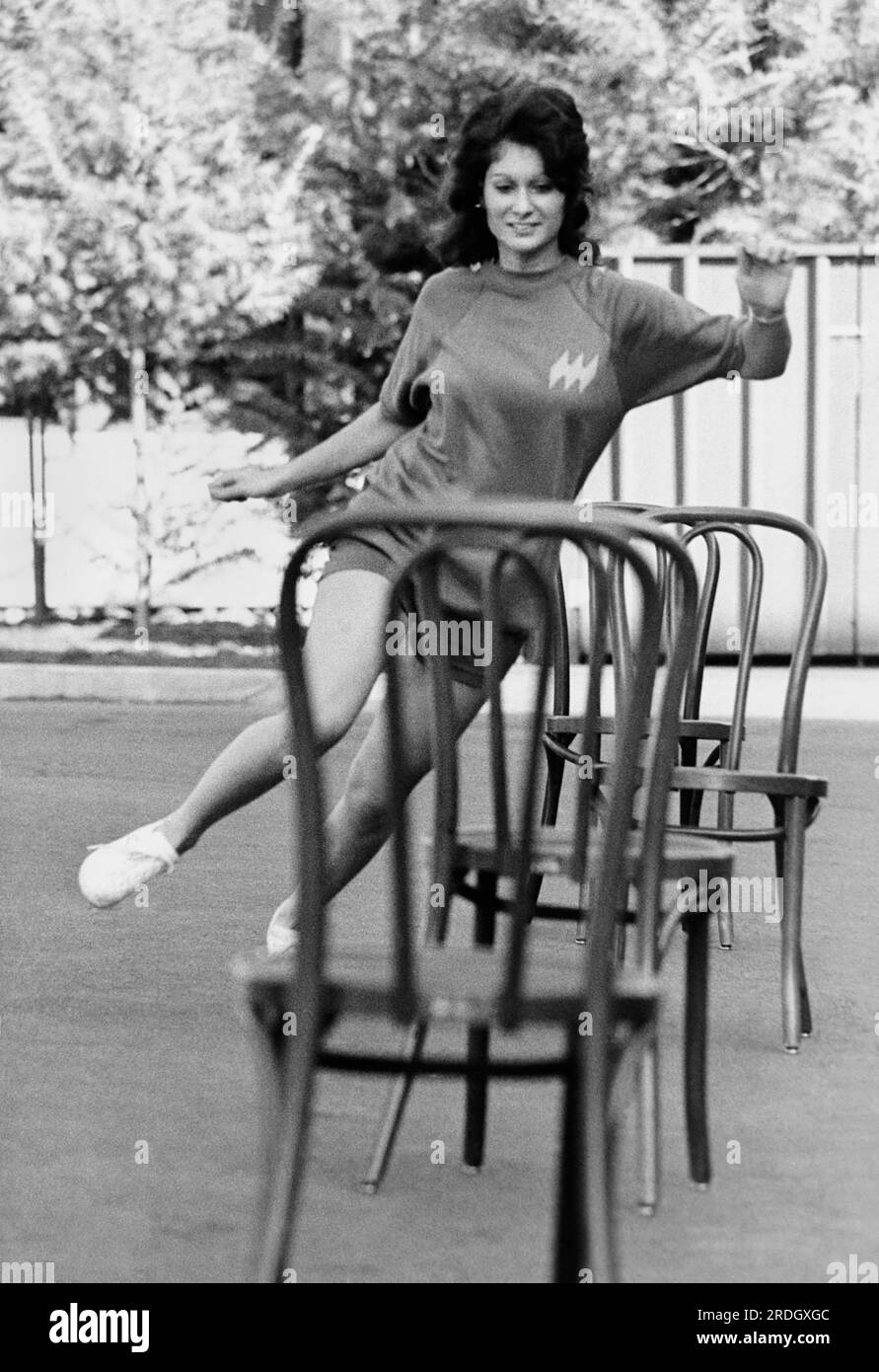 San Francisco, California:   c. 1975 Hughes Airwest stewardess trainees become the first in the industry to be certified physically fit by the YMCA. Trainee Linda Dellaripa negotiates the agility test. Stock Photo