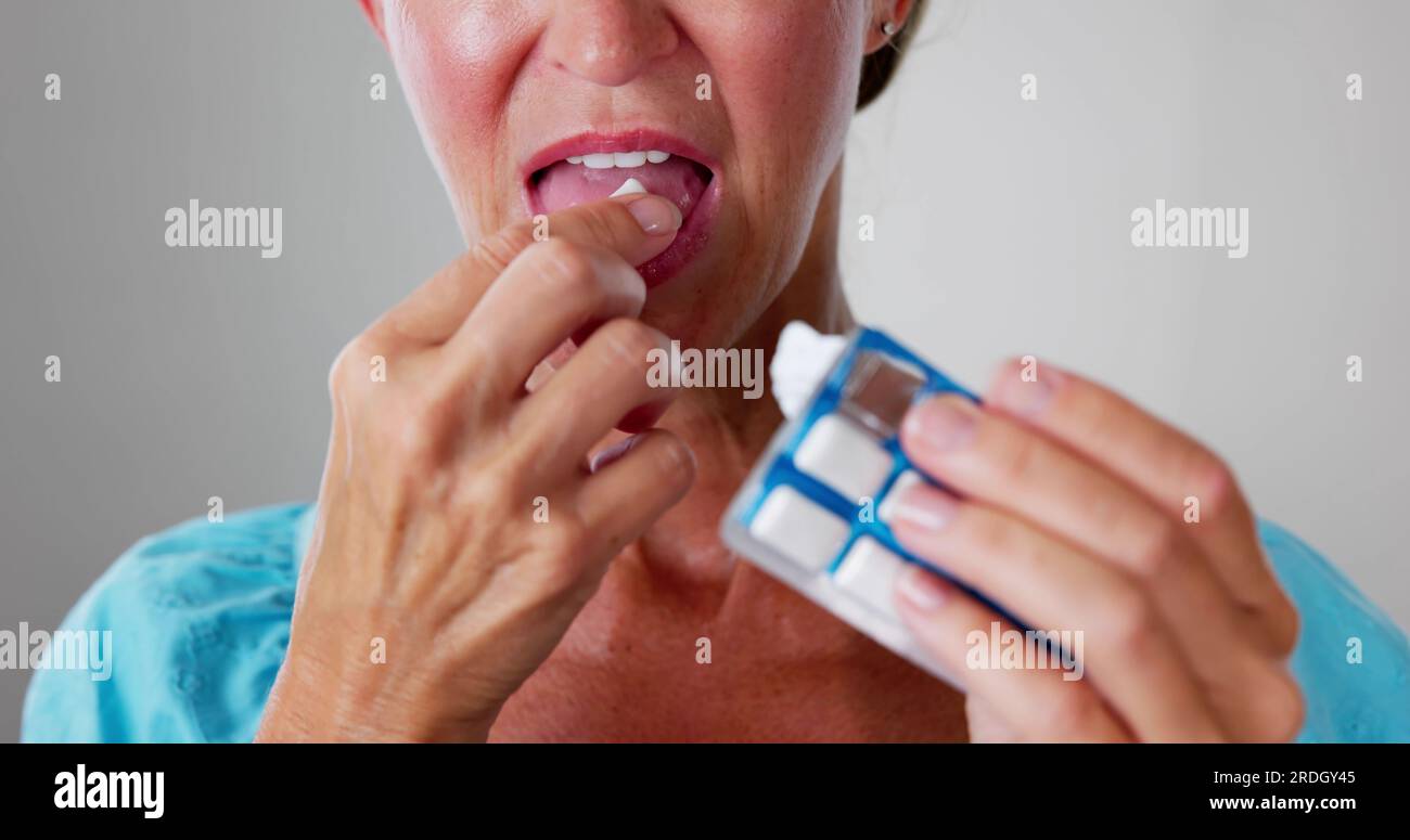 Woman Using Nicotine Gum To Quit Smoking. Nicotine Replacement Therapy