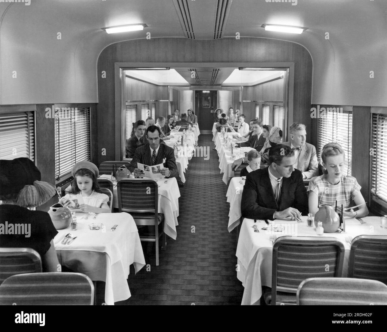 United States c. 1940. Passengers on a train in the dining car for