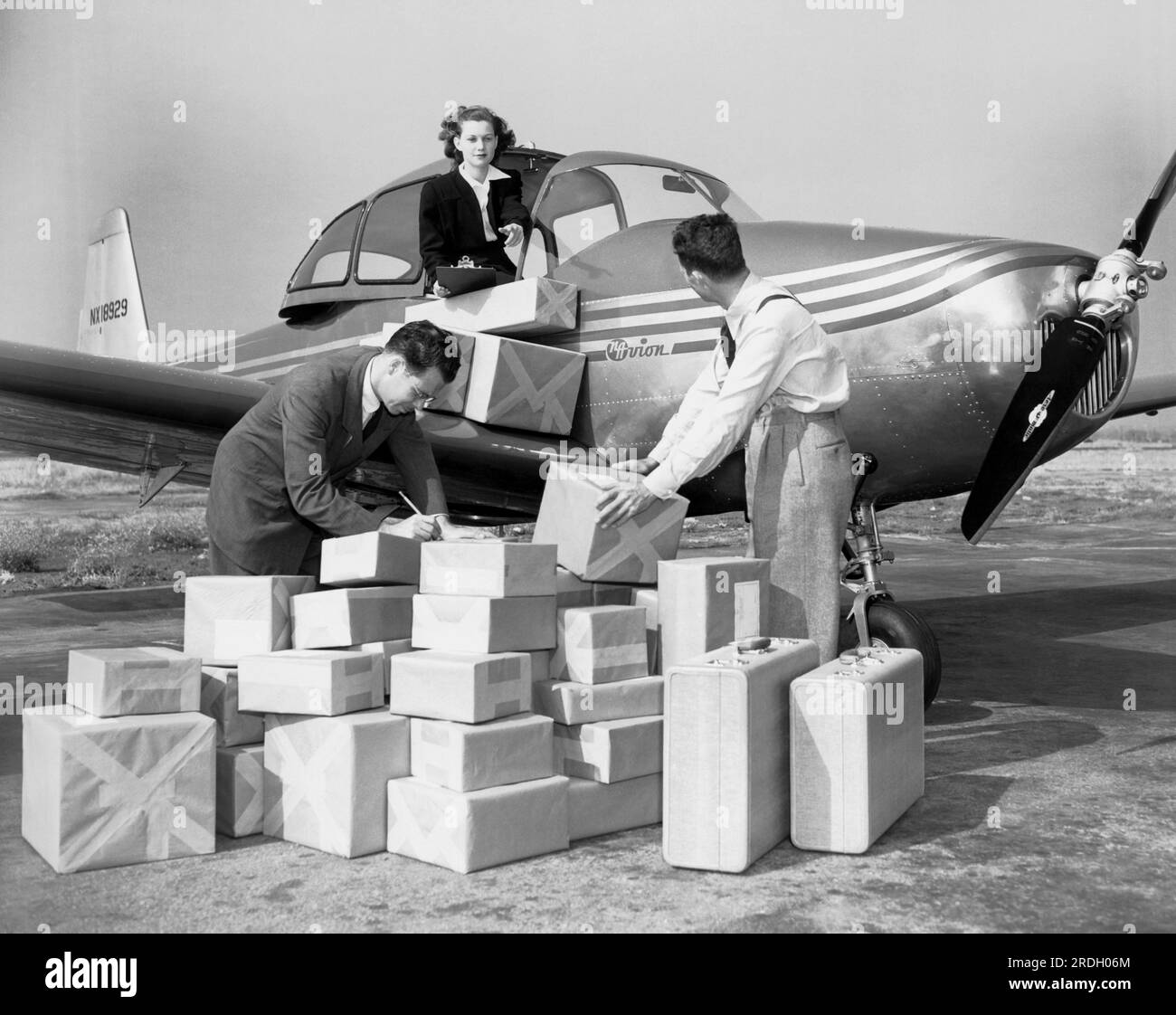 Los Angeles, California:  c. 1945 North American Aviation's new personal airccraft, the NAvion. Its capacity rivals that of the passenger car ans here personnel at Los Angeles Municipal Airport demonstrate it's 55 cubic feet and 610 pound capacities. Stock Photo