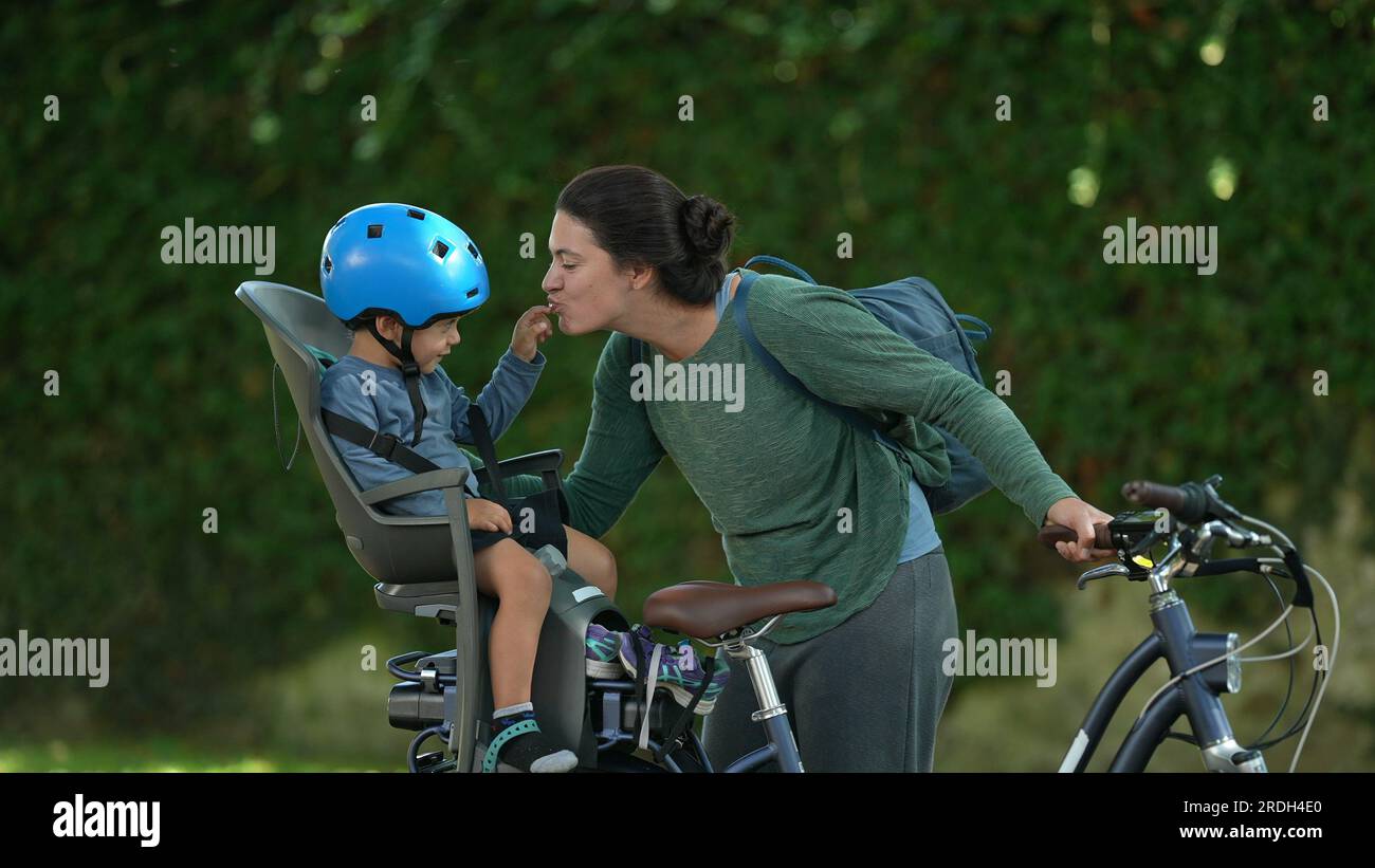 Mother and child loving moment together riding bicycle kid sitting on ...