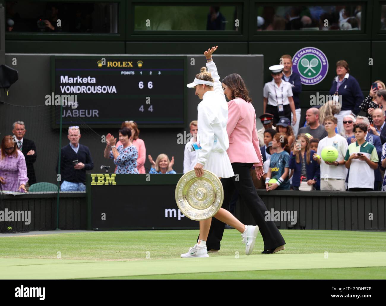 Marketa Vondrousova walks off with the winners trophy. Ons Jabeur