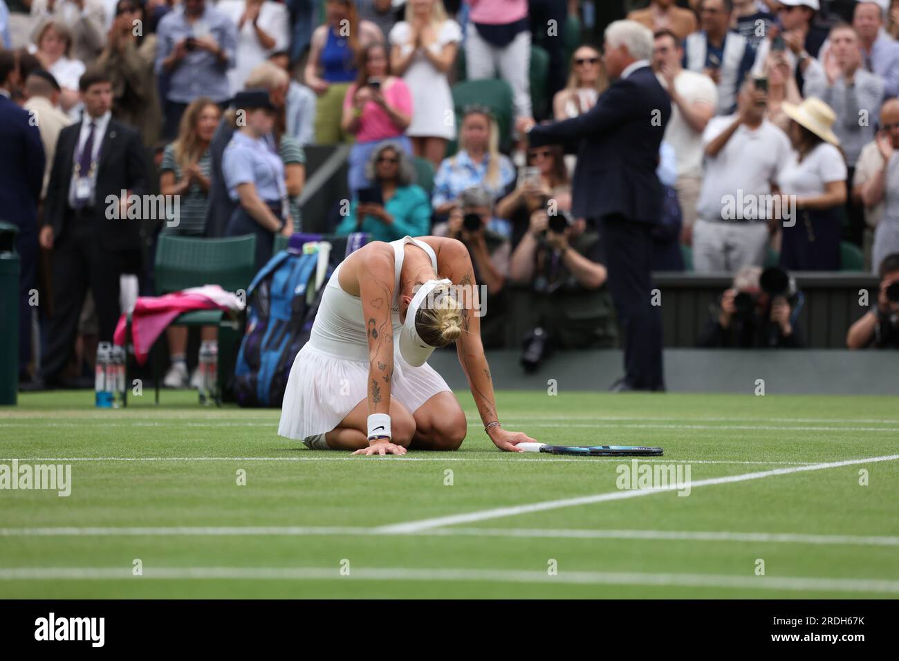 Marketa Vondrousova drops to the floor after beating Ons Jabeur in the