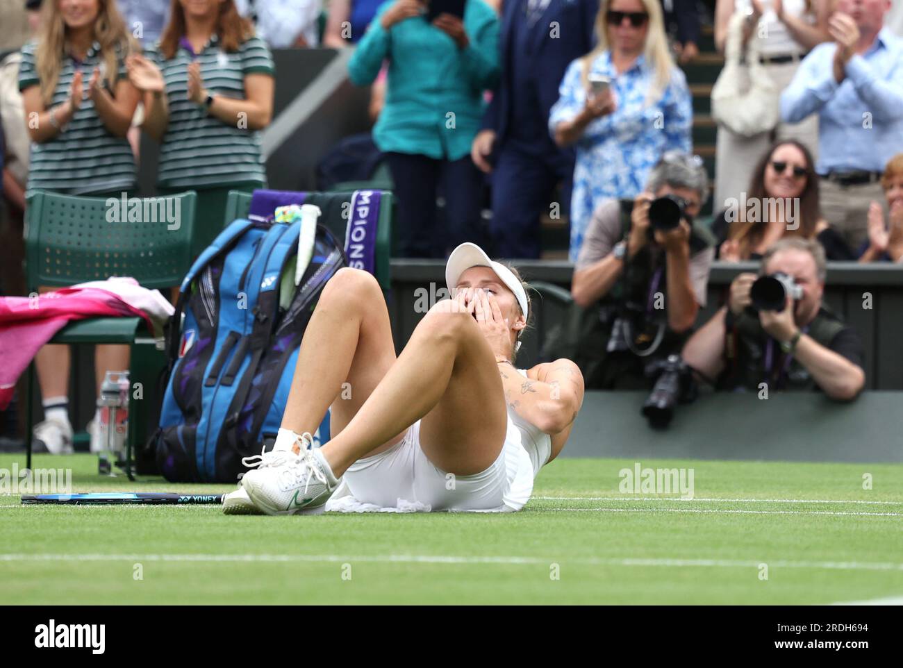 Marketa Vondrousova drops to the floor after beating Ons Jabeur in the