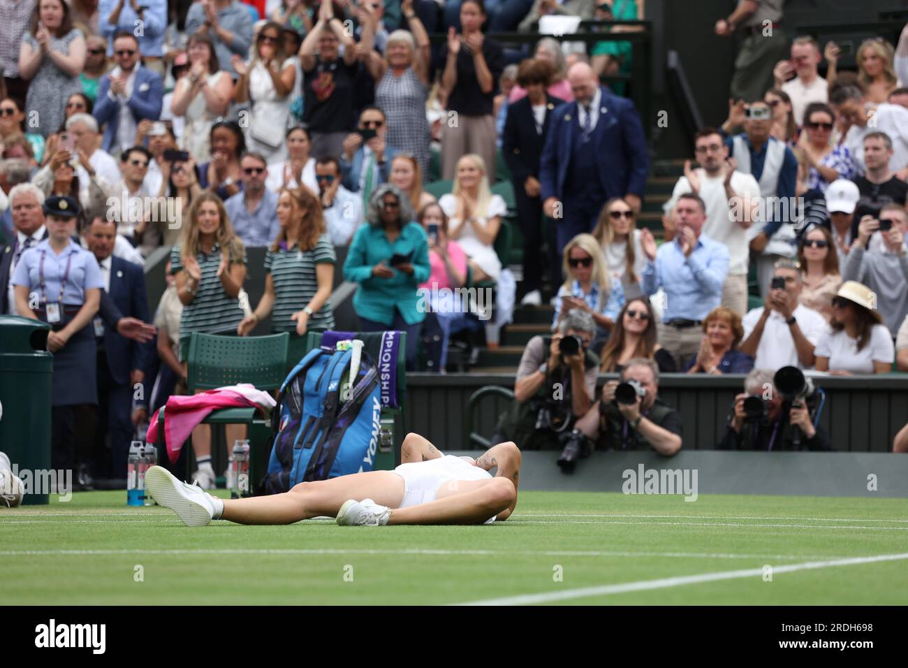 Marketa Vondrousova drops to the floor after beating Ons Jabeur in the
