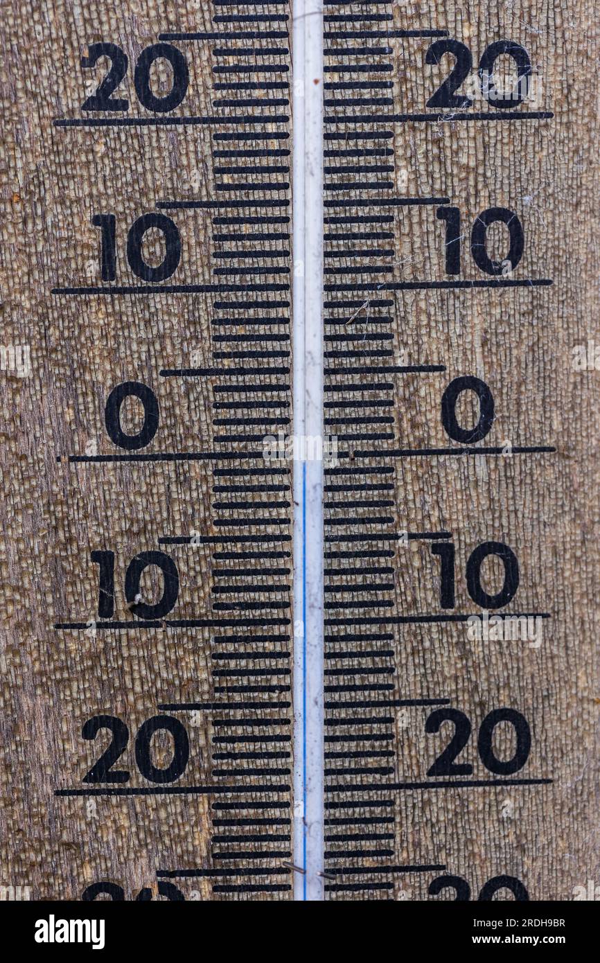 A close up portrait of a thermometer gauge indicating a temperature measurement of zero degrees