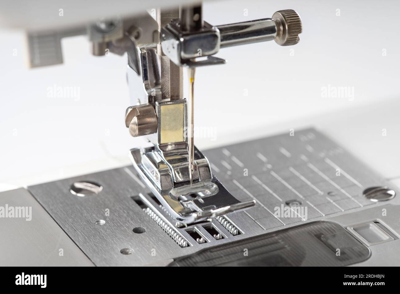 Modern white sewing machine presser foot closeup, macro. Sewing