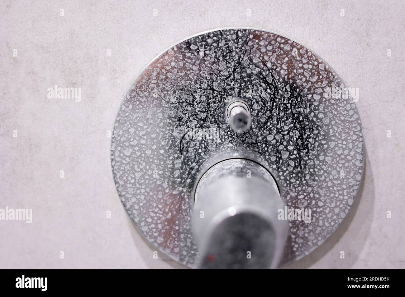 Dirty calcified shower mixer tap, faucet with limescale on it, plaque