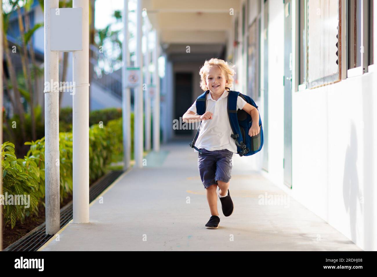 Child going to school. Boy running in school yard. Little student excited to be back to