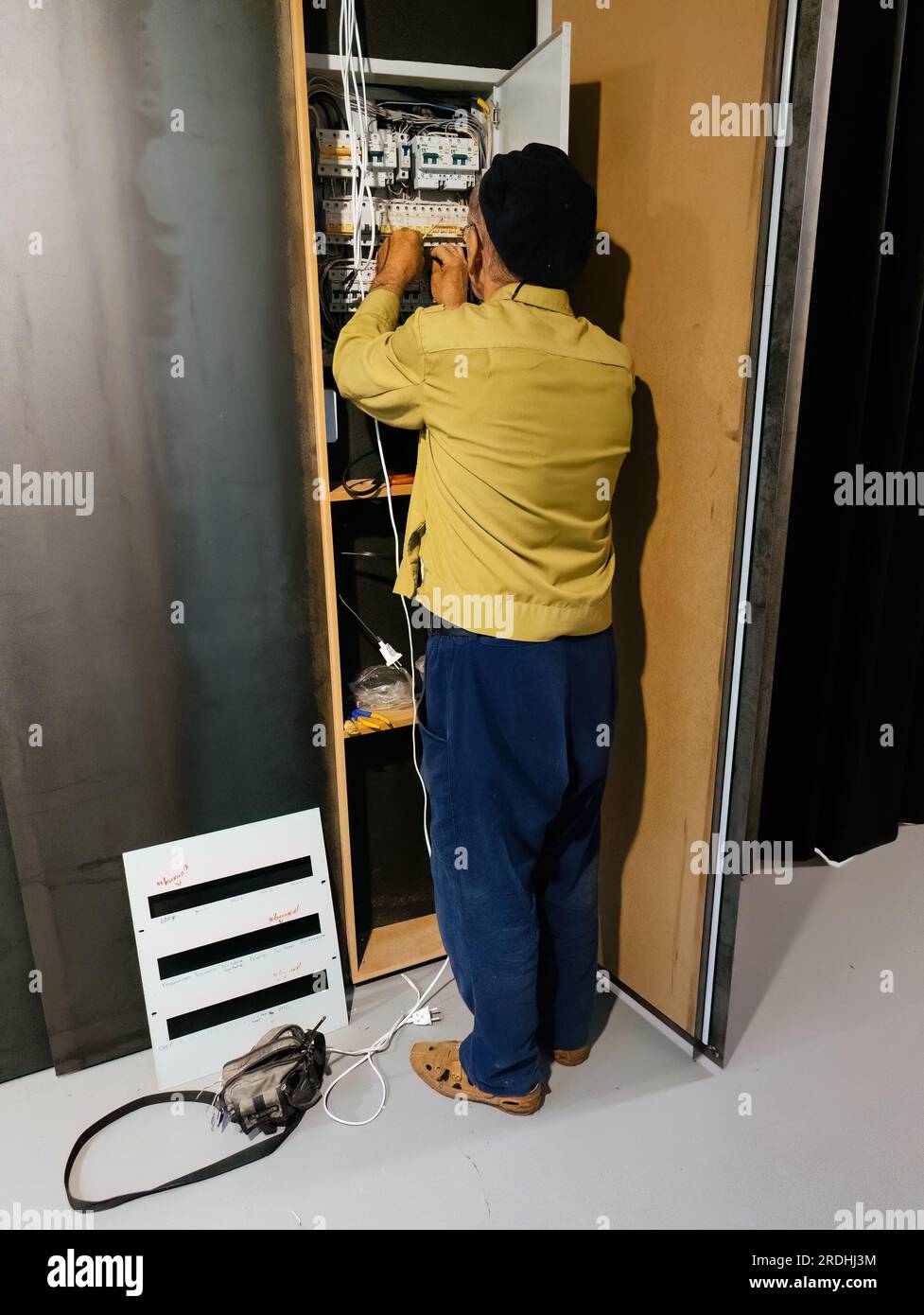 Electrician engineer repairing electrical switch box. Stock Photo