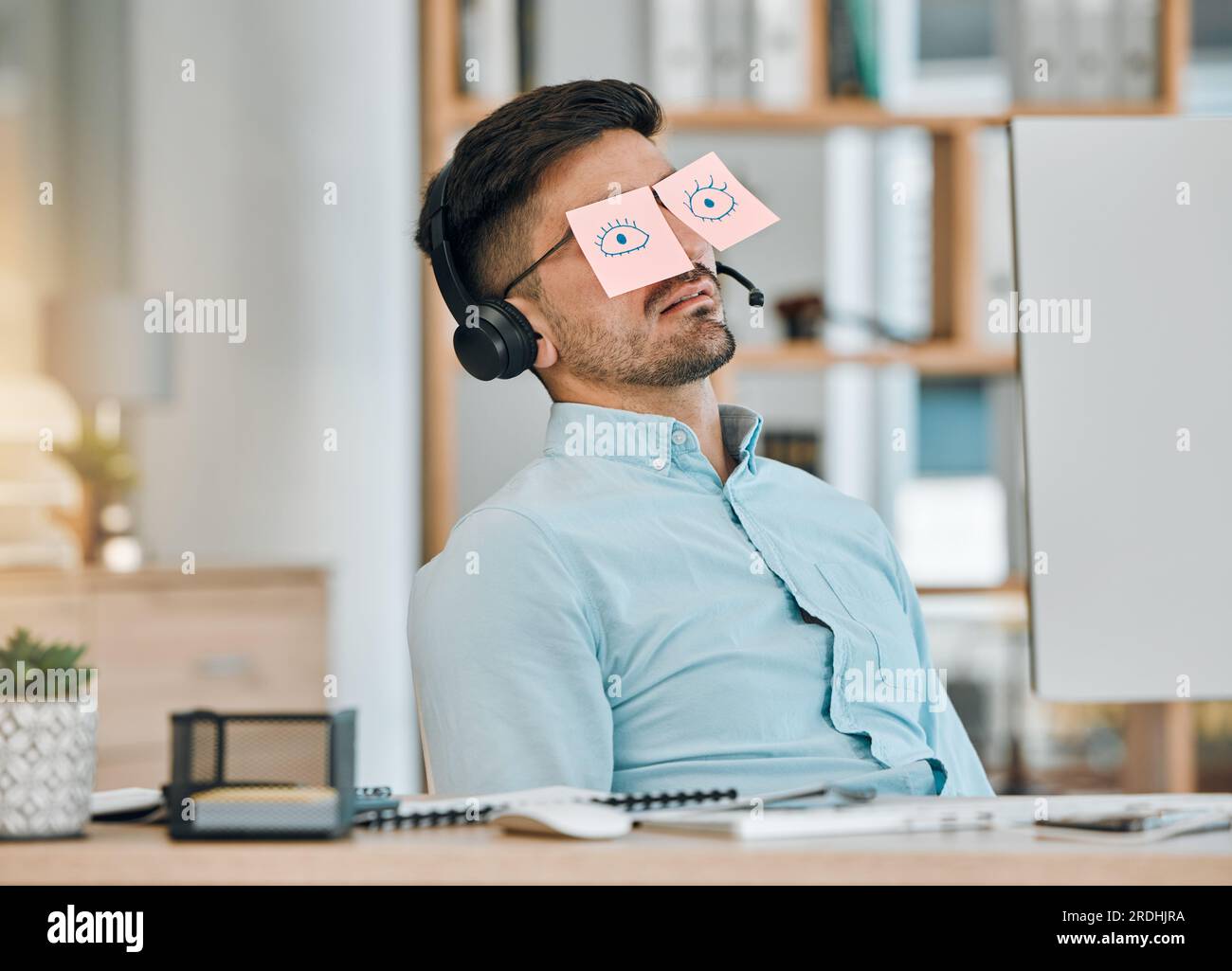 Tired, sleeping and business man with sticky note eyes from low energy and burnout at office desk. Fatigue, nap and rest of a male professional with Stock Photo