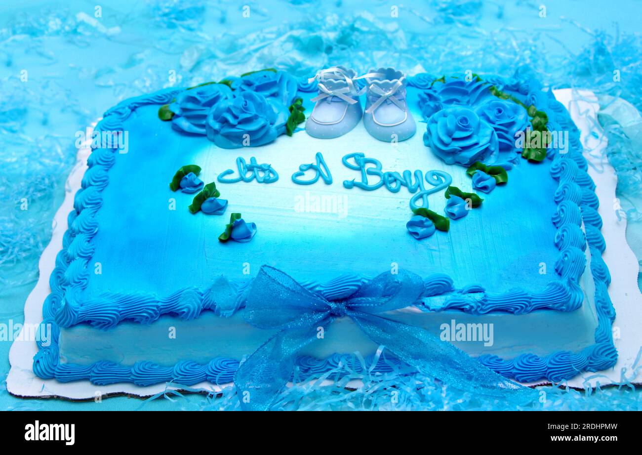 Bright blue sheet cake is decorated with blue roses and scalloped edges