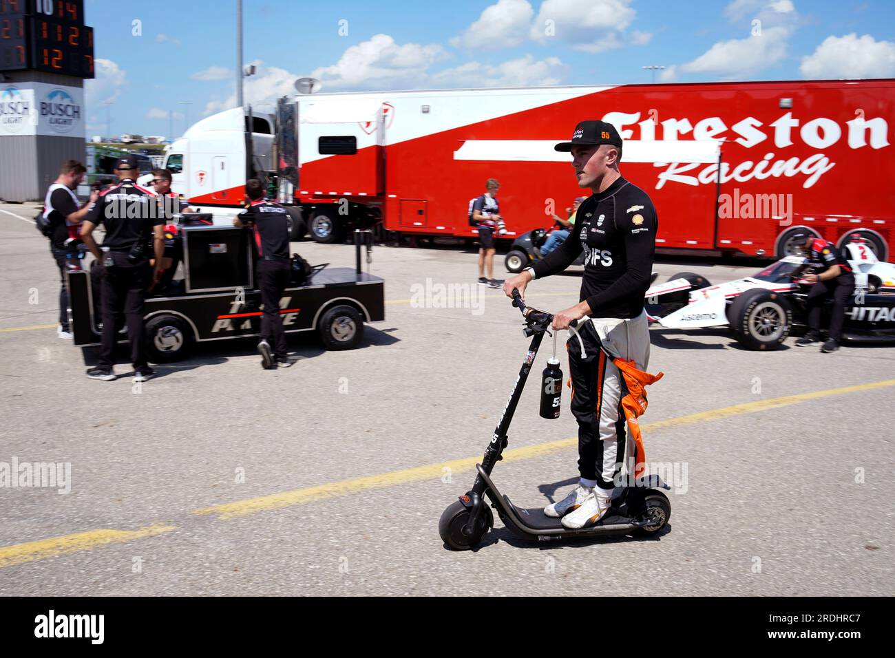 Benjamin Pedersen, of Denmark, rides a scooter in the garage area before  practice for an IndyCar Series auto race, Friday, July 21, 2023, at Iowa  Speedway in Newton, Iowa. (AP Photo/Charlie Neibergall