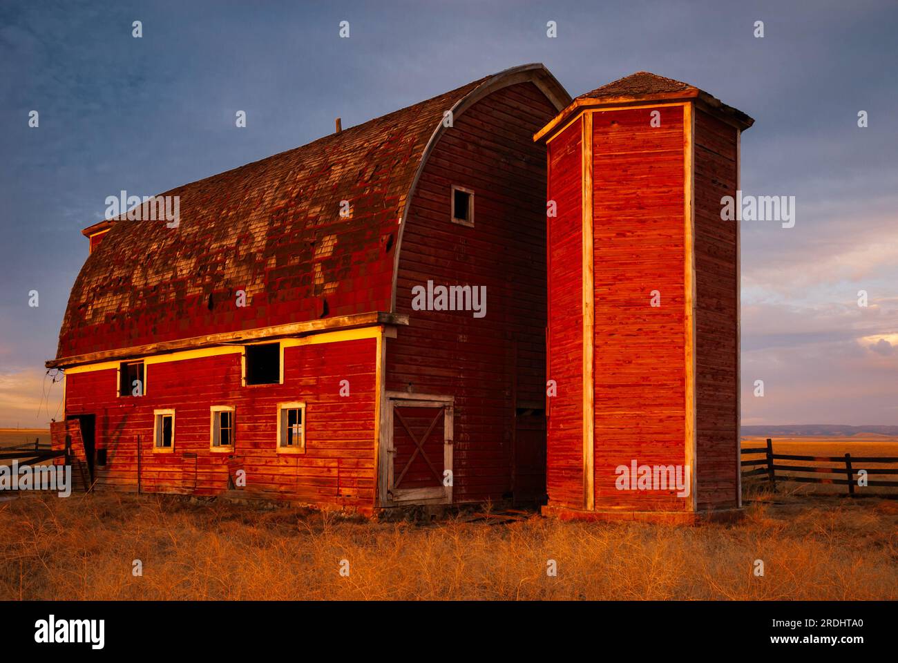Weathered Red barn with dual silos in morning light, Asotin County, Washington, USA Stock Photo