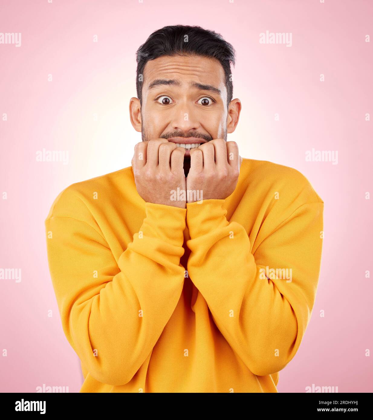 Anxiety, portrait and asian man biting nails in studio with terror ...