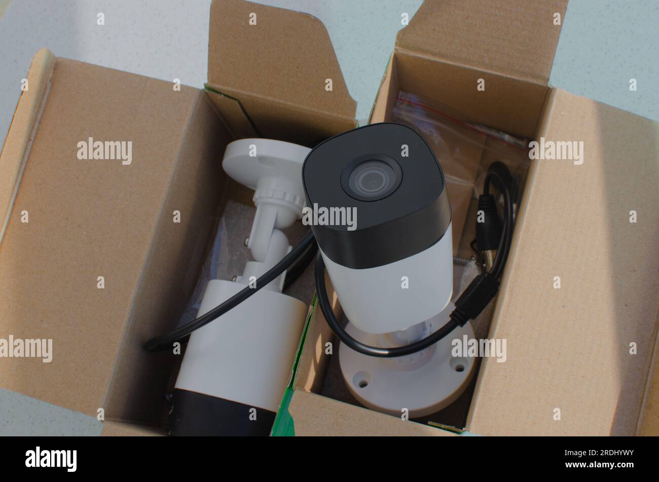 Two closeup security cameras, still in the box. Keep your environment