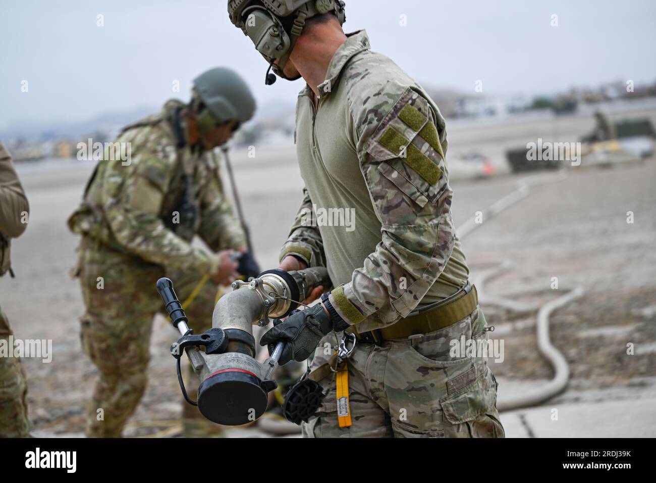 U.S. service members refuel an MH60 Black Hawk helicopter during