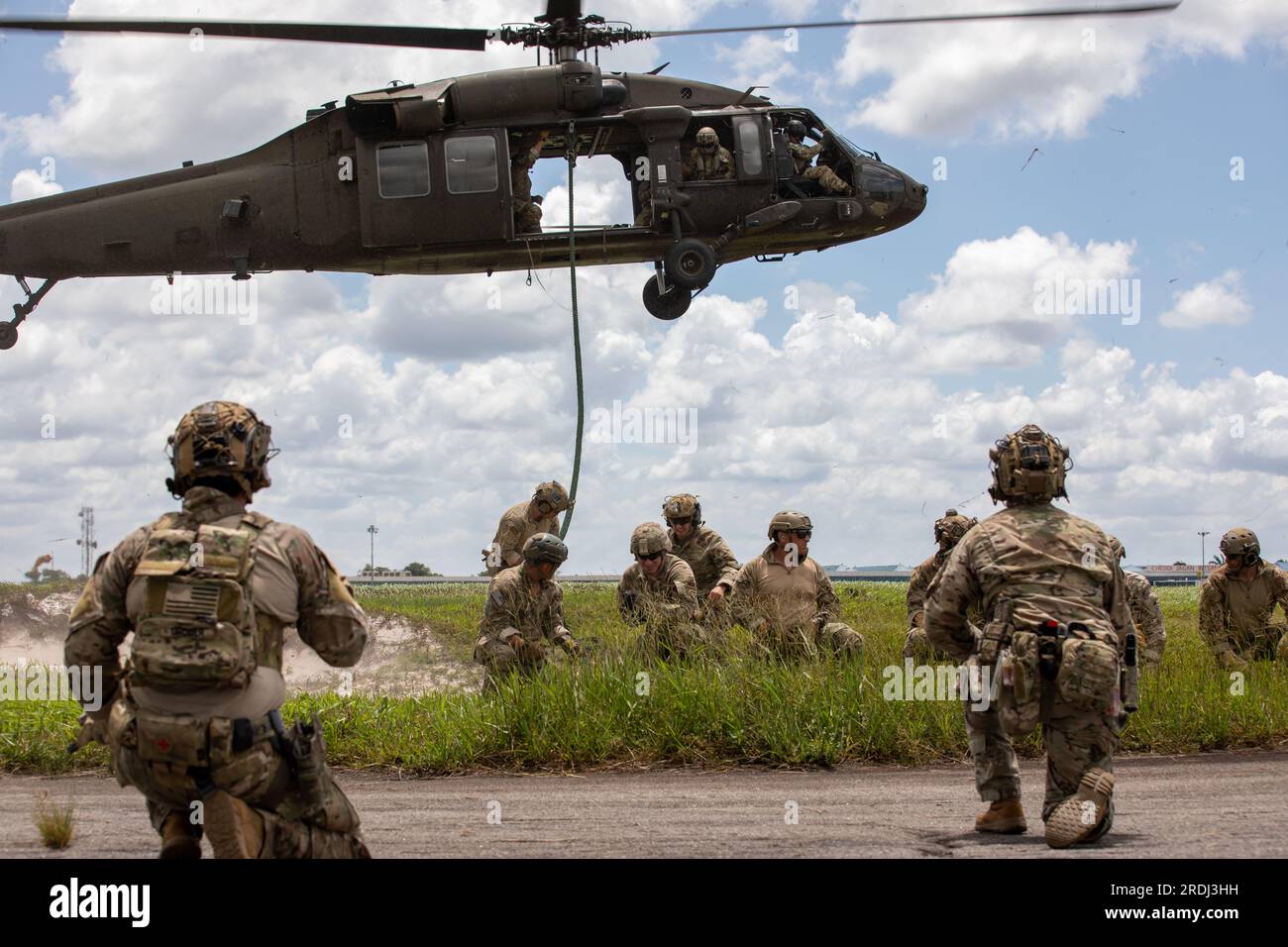 U.S. Army soldiers assigned to 7th Special Forces Group, perform fast rope drills out of a UH-60 Blackhawk with partner nations, during Tradewinds23 exercise, at Air Base London, Guyana, July 17, 2023. Tradewinds 2023 is a U.S. Southern Command sponsored multidimensional exercise, designed to strengthen partner nations across land, air, sea and cyber by focusing on security threats, interoperability, promoting human rights, and disaster and crisis management operations. (U.S. Army Reserve photo by Sgt. Mikayla Fritz) Stock Photo