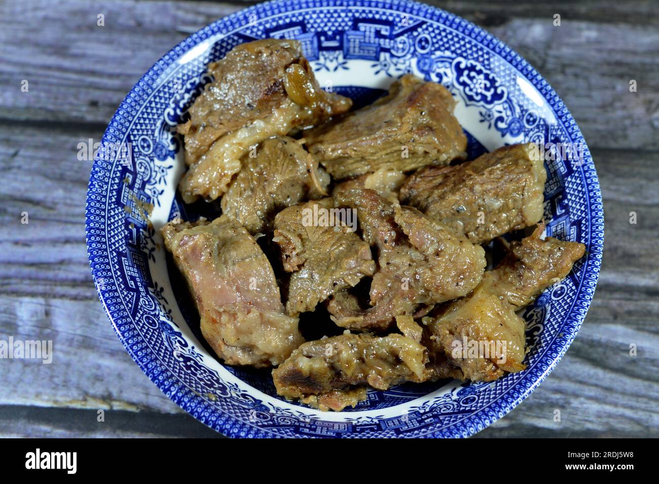 Pieces of roasted chopped meat beefsteak cooked with ghee with onion slices, salt and black pepper, bay laurel and cardamom, beef pieces, meat recipe Stock Photo