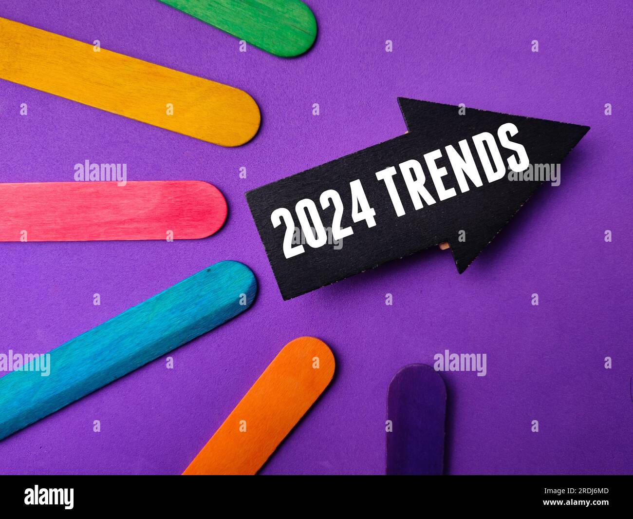 Black arrow with the word 2024 TRENDS on a purple background Stock